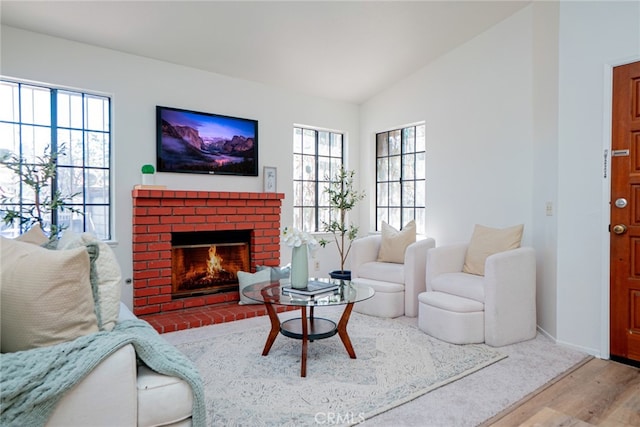 8541 San Clemente Dr, Rancho Cucamonga, CA 91730 - living area featuring lofted ceiling, wood finished floors, a fireplace, and baseboards