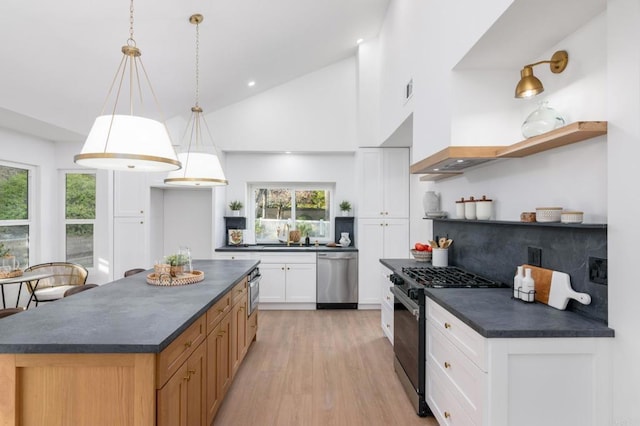 1142 Cabot Ct, Vista, CA 92081 - kitchen featuring black gas range, open shelves, dark countertops, stainless steel dishwasher, and high vaulted ceiling