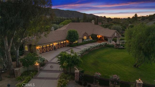 23965 Lawson Rd, Corona, CA 92883 - view of front facade with concrete driveway, a gate, a chimney, a mountain view, and an attached garage