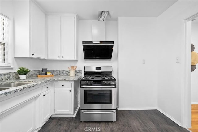 kitchen with stainless steel gas range, dark wood-style flooring, white cabinets, and baseboards