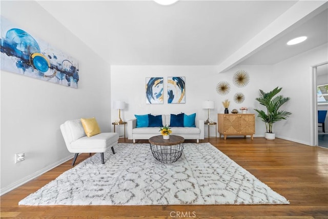 living area featuring wood finished floors and baseboards
