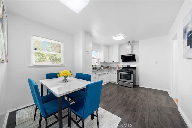 dining area with dark wood-style flooring and baseboards