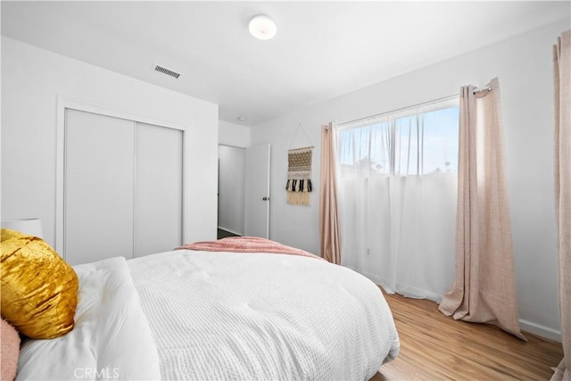 bedroom featuring a closet and light wood-style floors