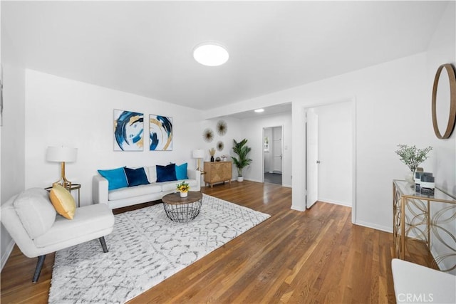 living area featuring baseboards and wood finished floors