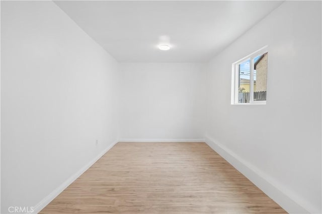spare room with light wood-type flooring and baseboards
