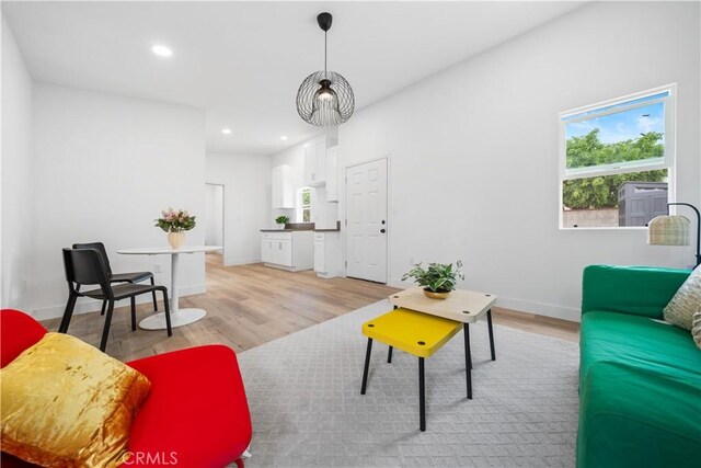 living area with light wood finished floors, recessed lighting, and baseboards
