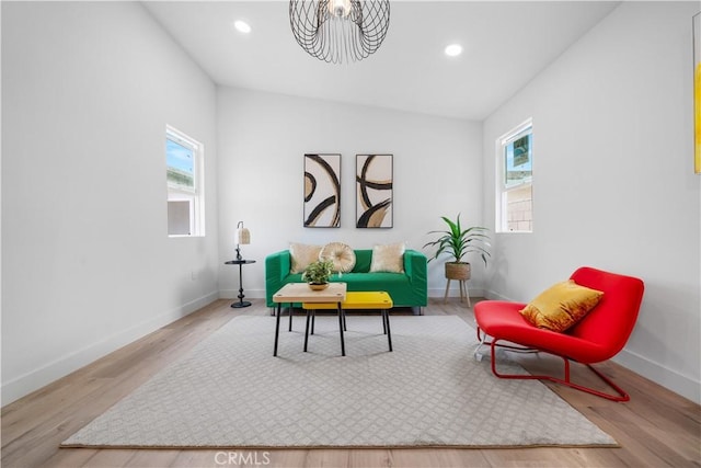 sitting room with healthy amount of natural light, baseboards, wood finished floors, and recessed lighting
