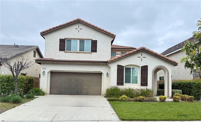 5610 Guardian Way, Chino, CA 91710 - mediterranean / spanish-style home featuring an attached garage, driveway, a front lawn, stucco siding, and a tile roof