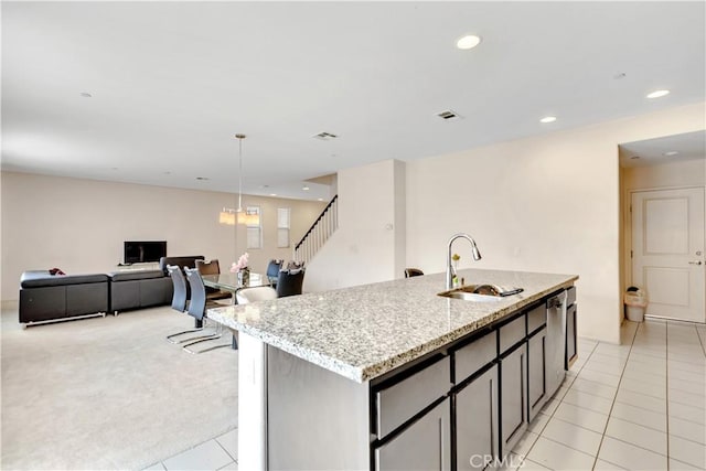 5610 Guardian Way, Chino, CA 91710 - kitchen featuring an island with sink, light tile patterned floors, light stone countertops, recessed lighting, and open floor plan
