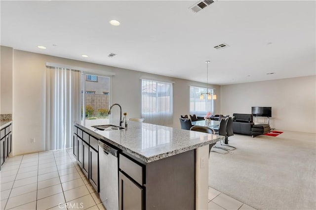 5610 Guardian Way, Chino, CA 91710 - kitchen with dishwasher, light tile patterned flooring, recessed lighting, an island with sink, and light stone countertops
