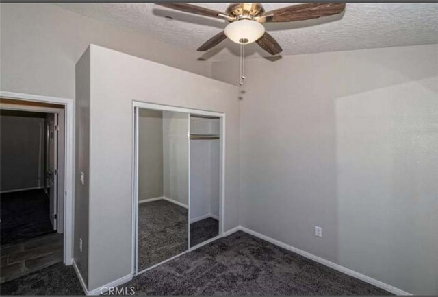 17602 Main St, Hesperia, CA 92345 - unfurnished bedroom featuring dark colored carpet, a textured ceiling, a closet, baseboards, and a ceiling fan