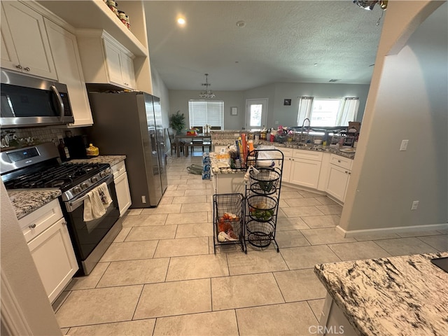 17602 Main St, Hesperia, CA 92345 - kitchen featuring stainless steel appliances, tasteful backsplash, light stone countertops, light tile patterned flooring, and a peninsula