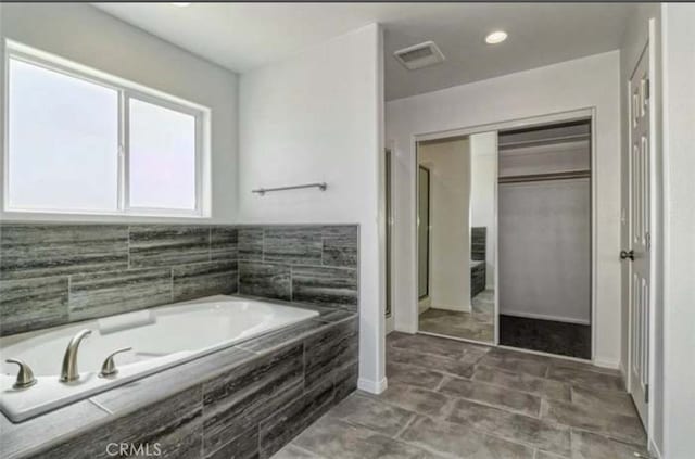 17602 Main St, Hesperia, CA 92345 - bathroom featuring a bath and baseboards