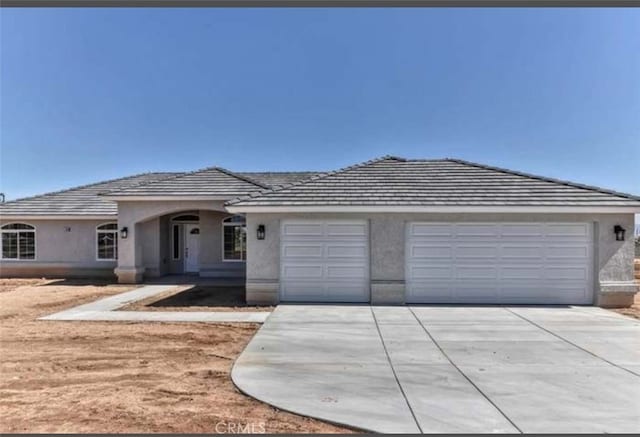 17602 Main St, Hesperia, CA 92345 - view of front of property with concrete driveway, a garage, and stucco siding
