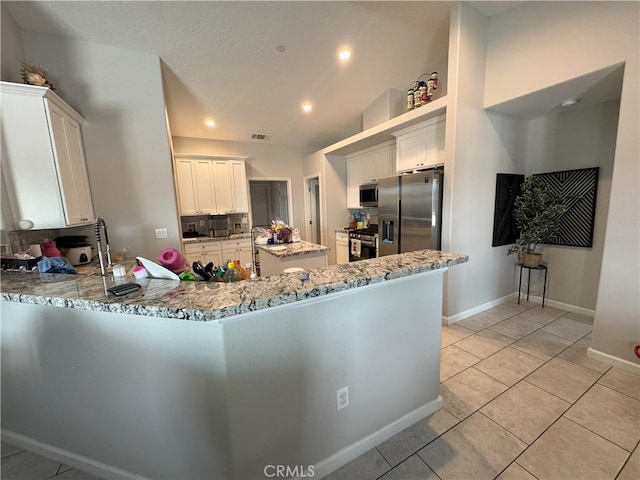 17602 Main St, Hesperia, CA 92345 - kitchen with stainless steel appliances, light stone counters, a peninsula, light tile patterned floors, and recessed lighting