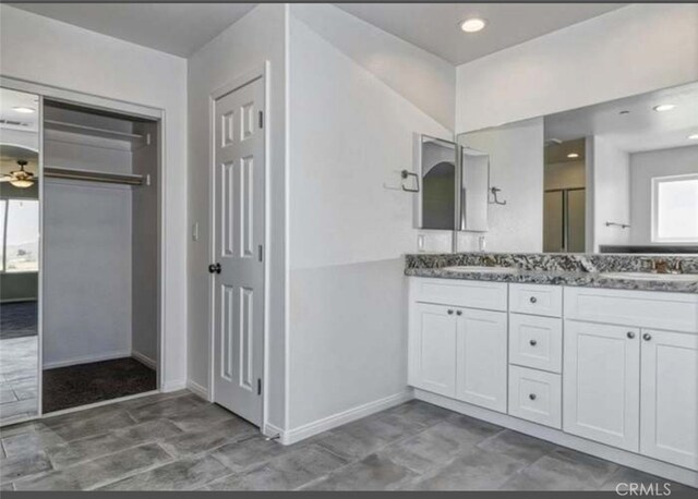 17602 Main St, Hesperia, CA 92345 - full bathroom with baseboards, double vanity, recessed lighting, and an enclosed shower