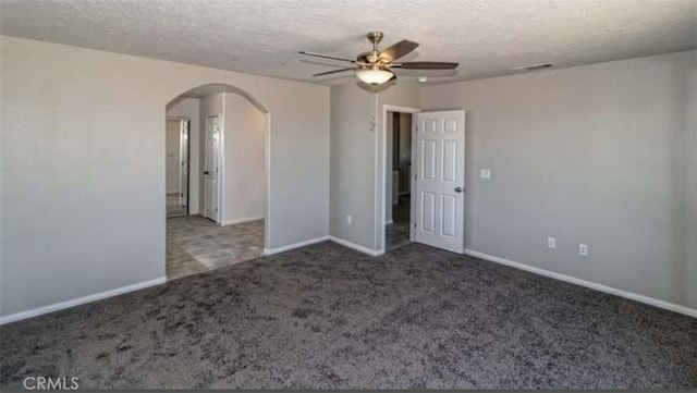 17602 Main St, Hesperia, CA 92345 - unfurnished room featuring arched walkways, a ceiling fan, carpet flooring, baseboards, and a textured ceiling