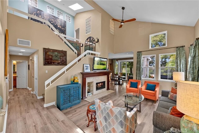 37 Giotto, Aliso Viejo, CA 92656 - living area featuring high vaulted ceiling, wood finished floors, stairway, ceiling fan, and baseboards