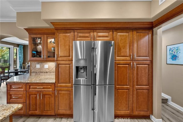 37 Giotto, Aliso Viejo, CA 92656 - kitchen with stainless steel fridge, light wood finished floors, light stone counters, brown cabinetry, and ornamental molding