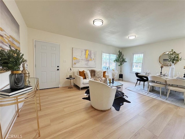 living area with light wood finished floors and baseboards