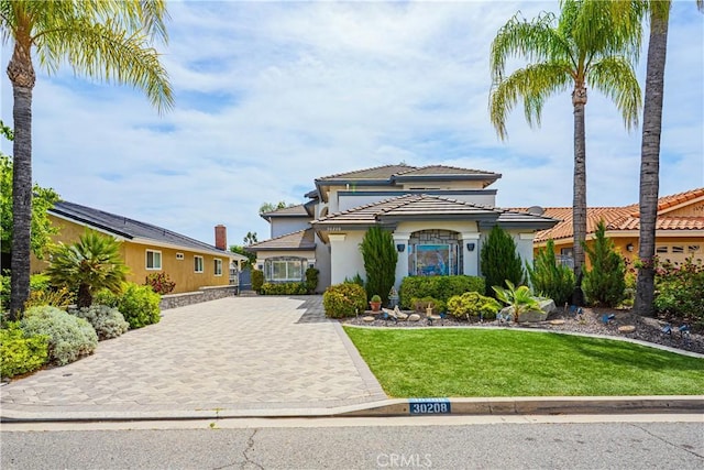 30208 White Wake Dr, Canyon Lake, CA 92587 - mediterranean / spanish-style house with decorative driveway, a tile roof, a front lawn, and stucco siding
