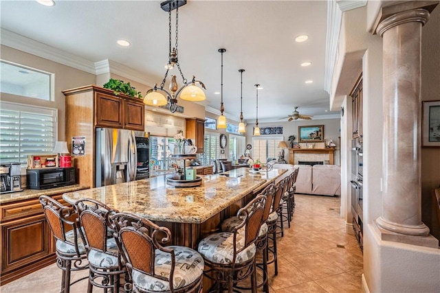 30208 White Wake Dr, Canyon Lake, CA 92587 - kitchen with stainless steel refrigerator with ice dispenser, ornate columns, open floor plan, a kitchen breakfast bar, and light stone counters