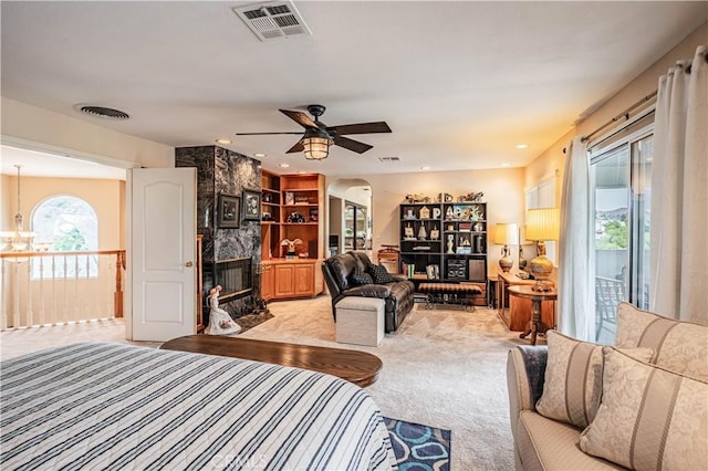 30208 White Wake Dr, Canyon Lake, CA 92587 - bedroom with access to exterior, a chandelier, light carpet, arched walkways, and a fireplace