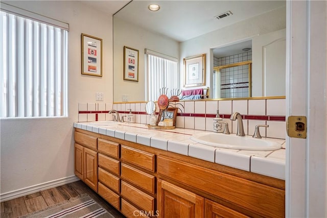 30208 White Wake Dr, Canyon Lake, CA 92587 - full bathroom featuring wood finished floors, plenty of natural light, double vanity, and a stall shower
