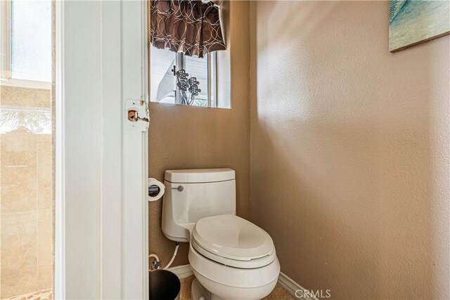 30208 White Wake Dr, Canyon Lake, CA 92587 - bathroom featuring baseboards, plenty of natural light, a textured wall, and toilet