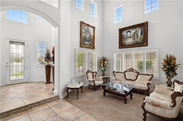 13985 Evergreen Ln, Victorville, CA 92395 - living area featuring a high ceiling, arched walkways, tile patterned floors, and baseboards
