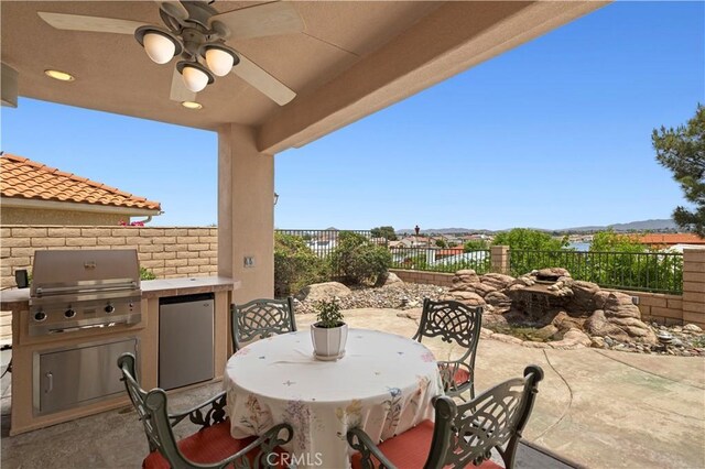 13985 Evergreen Ln, Victorville, CA 92395 - view of patio with grilling area, outdoor dining space, a fenced backyard, a ceiling fan, and area for grilling