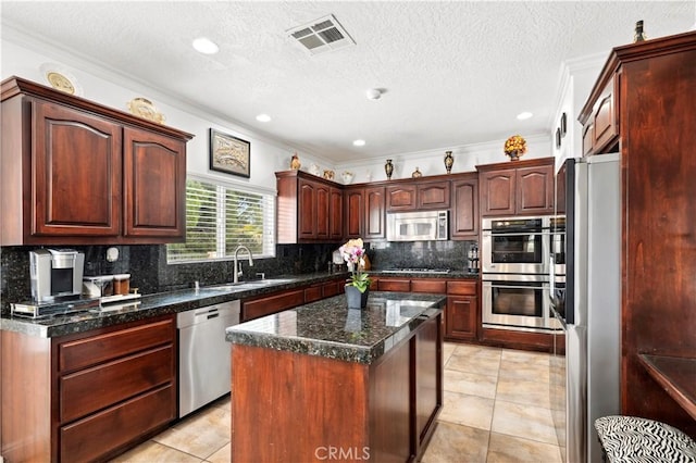 13985 Evergreen Ln, Victorville, CA 92395 - kitchen with appliances with stainless steel finishes, a sink, decorative backsplash, crown molding, and light tile patterned floors
