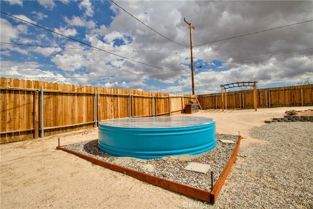 fenced backyard featuring a pool