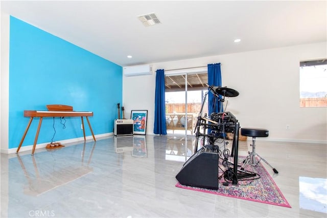 exercise area featuring baseboards and a wall unit AC