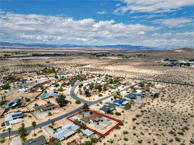 view of rural area with property parcel outlined, a mountainous background, and a desert landscape