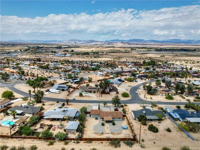 aerial perspective of suburban area with a mountainous background and a desert landscape