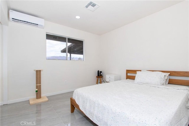 bedroom with a wall unit AC, baseboards, and recessed lighting