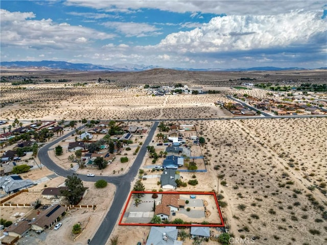 aerial view of property and surrounding area with property boundaries highlighted and mountains
