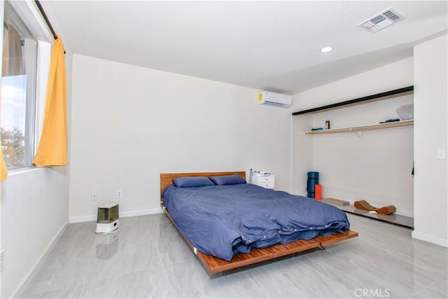 bedroom with a wall mounted air conditioner, baseboards, and recessed lighting