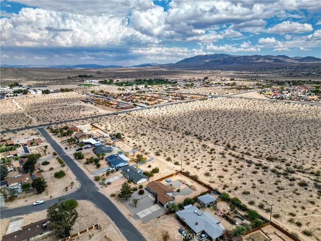 drone / aerial view of a mountain backdrop and a desert landscape