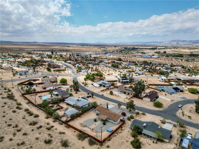 aerial perspective of suburban area with a mountainous background and a desert landscape