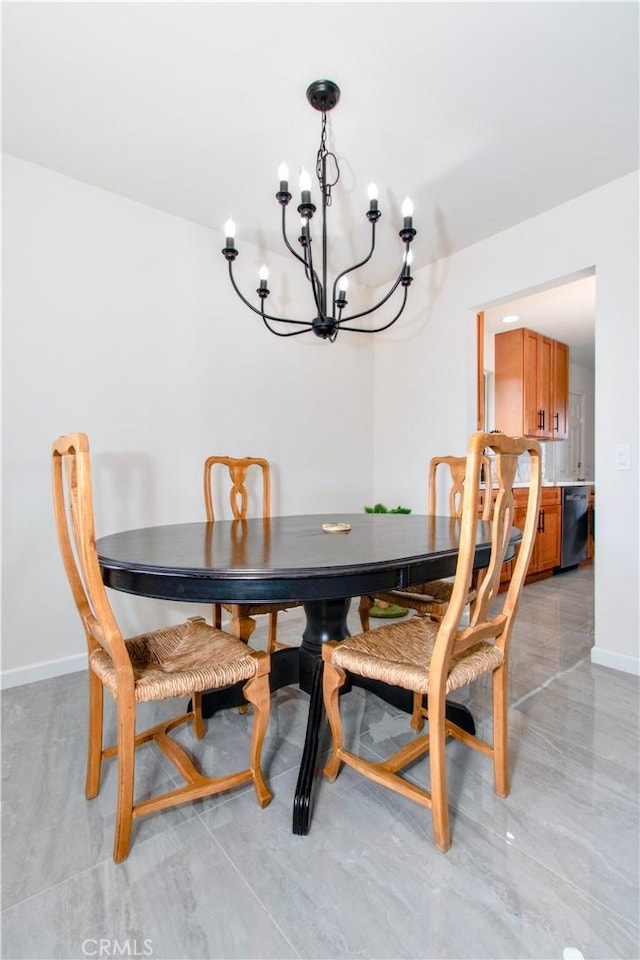 dining area with a chandelier and baseboards
