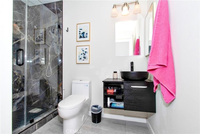 full bath with a marble finish shower, toilet, baseboards, and vanity