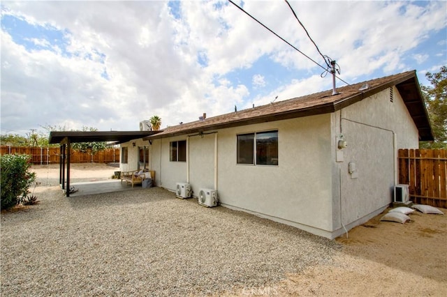 back of house with fence, a patio area, stucco siding, and central air condition unit