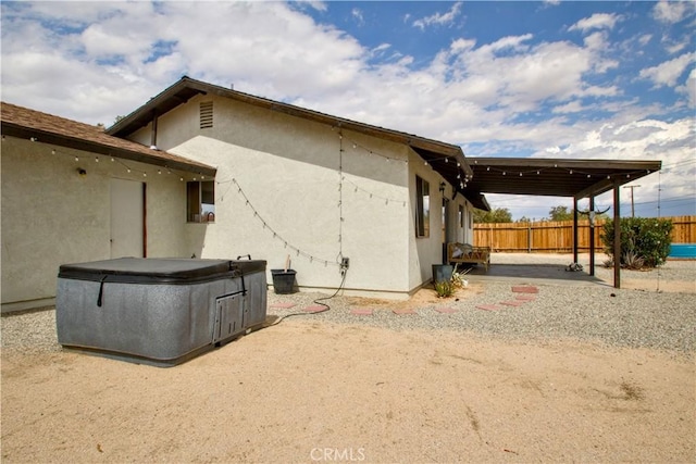 back of house featuring fence, stucco siding, and a patio area