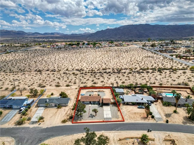 aerial view of property's location with property boundaries highlighted and a mountain backdrop