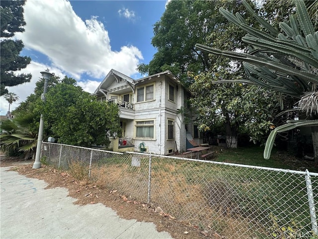 view of side of home with a balcony