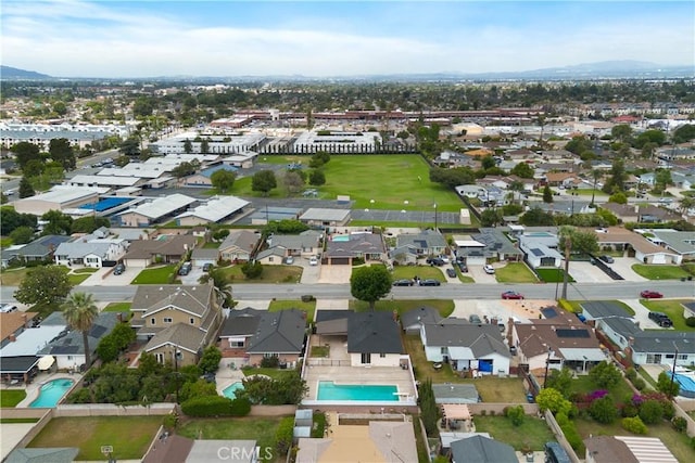 716 S Armel Dr, Covina, CA 91723 - aerial view of property's location with a pool, mountains, and nearby suburban area