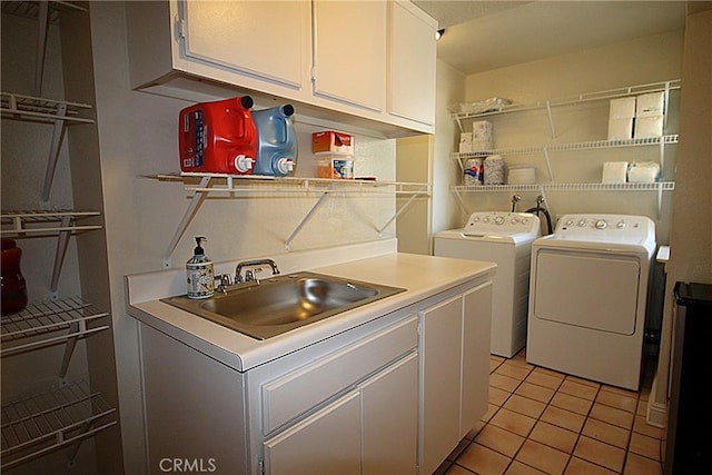 6102 Cabriolet Ct, Quartz Hill, CA 93536 - clothes washing area featuring washing machine and clothes dryer, cabinet space, and light tile patterned floors