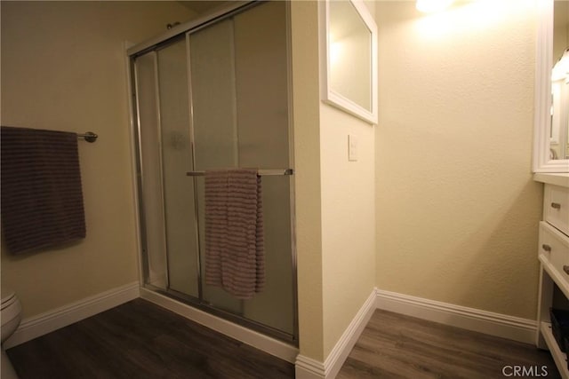 6102 Cabriolet Ct, Quartz Hill, CA 93536 - full bath with wood finished floors, a stall shower, vanity, baseboards, and toilet